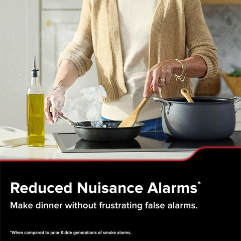 User cooking in kitchen with Hardwired Smart Smoke Detector With App Alerts And AA Backup To Halt False Alarms Fast And Keep You Looped In On Dangers Anywhere With Whole Home Linking For Serious Peace Of Mind.