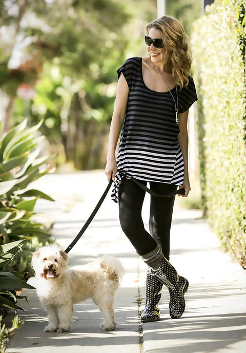 Women Mid Calf Waterproof Garden Rain Boots With Killer Traction And Legit All Day Comfy Support Insole For Yard Work Or Rainy Days Snazzy Black And White Polka Dot Style Made Stateside True To Size, worn outdoors while walking a dog.