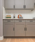 30 Pack Solid 3 Inch Cabinet Handles Matte Black Zinc Alloy Pulls for Kitchen Cupboards and Drawers, installed on grey cabinets