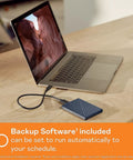 2TB Portable External Hard Drive For Mac Navy With Backup Software shown connected to a laptop via USB cable on a wooden desk