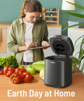 Woman using Electric Kitchen Compost Bin For Indoor Countertop With 3 Modes, Odor Free Carbon Filter System, Eco Friendly Smart Waste Recycler, Converts Food Scraps To Fertilizer For Your Garden, Low Mess on kitchen counter