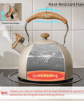 Stove Top 2.5 Quart Whistling Tea Kettle With Food Grade 18 8 Stainless Steel Wood Pattern Folding Handle Creamy White Finish Fast Heating Easy Clean Includes Silicone Heat Insulation Pad on stove