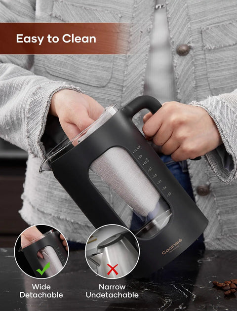 Person holding Glass Electric Tea Kettle With Tea Infuser And Precise Temperature Knob 1200W Fast Heating BPA Free Easy To Clean