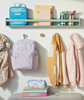 Various labeled items including jackets, backpacks, and notebooks organized using Portable Handheld Label Maker With QWERTY Keyboard And 2 Line Printing, 5 Font Sizes, 7 Print Styles, 8 Box Styles, Includes 13 Ft Black On White And Black On Clear Label Reels, Perfect For Home Organization, Crafting, And Quick Labeling.