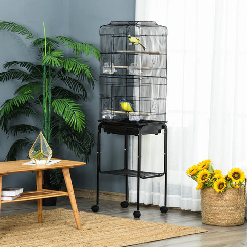 Heavy Duty Sixty Inch Metal Bird Cage With Easy Rolling Stand And Handy Storage Basket For Small Parrots Budgies Plus Full Pet Start Kit Accessories Ready To Treat Your Feathered Crew Black Indoor Flight Habitat with birds inside.