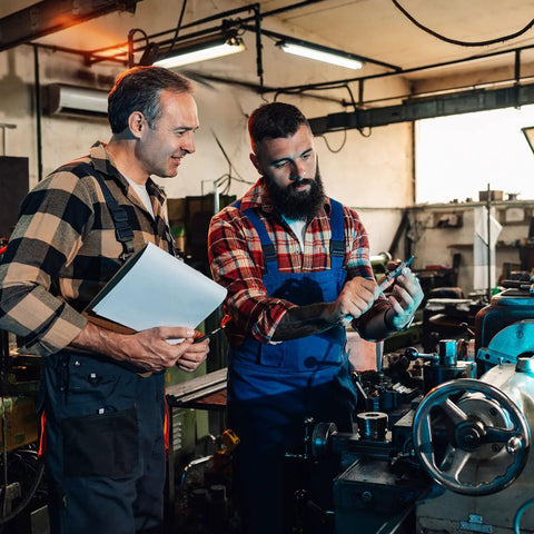 Two men discussing machinery next to an Aluminum Lathe Hand Wheel 50mm OD 5mm Bore With Rotating Handle for Milling Machines.
