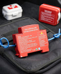Reliable Auto Aerosol Fire Extinguisher A Straight Up Weekend Warrior Must Have For Under The Hood Emergencies Quick Automatic Engine Bay Suppression Compact Car Safety Gear red aerosol fire extinguisher with blue handle on a dark bag