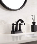 Matte Black 4 Inch Bathroom Sink Faucet With Three Hole Centerset Two Handles Metal Casting Spout Sleek Modern RV Farmhouse Vanity Faucet Include Drain With Overflow And Lift Rod on white countertop