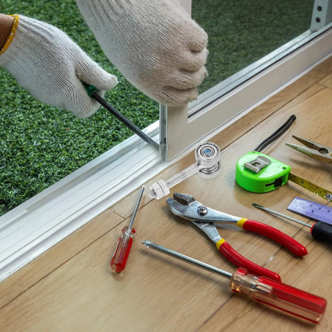 Person installing Rock Solid Heavy Duty Sliding Door Roller featuring dual bearings with tools for closet track replacement.