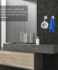 6 Pcs Stainless Steel Wall Hooks Zero Damage Install No Sweat Mount Heavy Duty Coat And Hat Hangers Punch Free Bath Towel Hooks Kitchen Racks Ridiculously Sturdy Versatile Home Storage Solution Gift Set holding blue towel and bath scrub in modern bathroom.