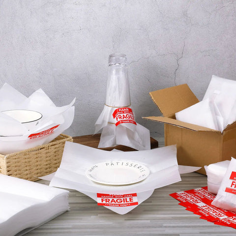 Heavy Duty Foam Packing Sheets For Moving And Shipping With Extra Fragile Labels cushioning dishes, glasses, and a bottle.