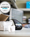 No Sweat Direct Thermal Label Printer With Zero Ink Hassles on desk next to packaging materials for easy organization.