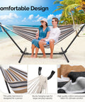 Couple relaxing on 550 lb capacity double hammock with stand, desert stripe design, suitable for outdoors and indoors.