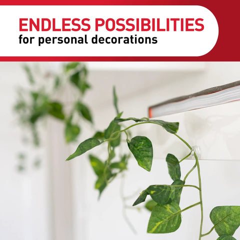 Damage Free Indoor Mini Light Clips Value Pack With 45 Clips And 54 Strips in use holding a green vine on a white wall.