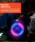 Encore Essential 2 Portable Party Speaker With AI Sound Boost Battery Powered next to people enjoying a light show