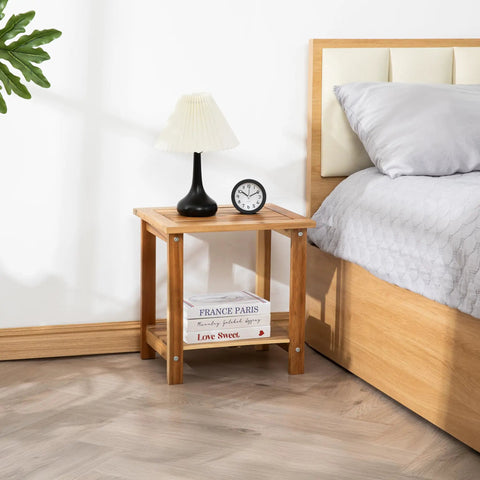 Solid Acacia Wood Side Table With Two Tier Storage For Indoor And Outdoor Use No Fuss Assembly End Table For Living Room And Patio Weather Resistant Light Natural Rustic Finish shown by a bed