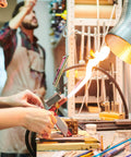 Person using tools in workshop with equipment and supplies, focusing on precise workbench setup in lab for electrolysis experiments