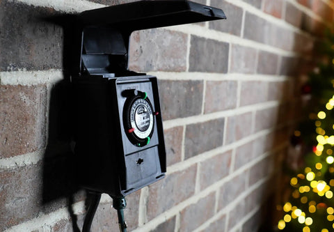Heavy Duty Outdoor Plug-In Timer Built Tough For Pool Pumps And Yard Lights, Boasts A Sealed Weatherproof Flip Cover, mounted on a wall.