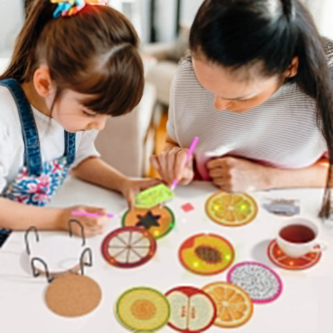 Adults and child using Diamond Art Coaster Kit With Holder, 12 Piece DIY Diamond Dot Coasters For Adults And Newbies, Includes Cork Bases, Colorful Diamonds, Glue, Pen, Tray, Holder And All Accessories, Fruit Style Craft Project.