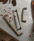 Vintage Brass Zinc Alloy Cabinet Handles Set Of 6 5.03 Inch Center To Center Antique Retro Pulls on stone surface