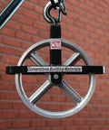Heavy Duty 12 Inch Aluminum Scaffold Hoist Pulley Wheel Kit With Safety Latch Swivel Hook And Reinforced Support Arm For Locking Frames Built Tough Quick Rig Dark Green close-up of pulley and hook.