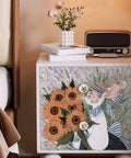 A nightstand featuring pretty sunflower and butterfly art, decorated with eight ceramic kitchen cabinet drawer knobs.