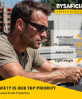 Bulk Pack Of Twenty Four Tinted Safety Glasses With Smoke Lenses And UV Protection Premium Polycarbonate Build Meets Ansi Z87 Standards on a worker.