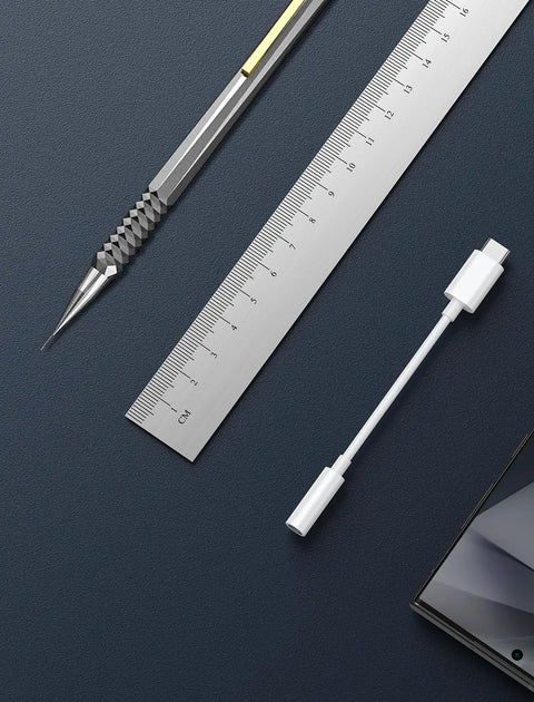 Premium Usb C To 3.5Mm Audio Adapter With Smart Dac Chip next to a ruler and stylus on a dark background.