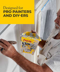 Professional painter using Purdy 140910300 Wire Brushes Block for surface prep, holding Purdy paint tray, designed for pros and DIYers.