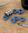 10-Pack MR115-2RS Miniature Deep Groove Ball Bearings Featuring Double Rubber Seals And Chrome Steel Construction on a wooden surface.