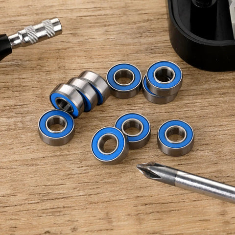 10-Pack MR115-2RS Miniature Deep Groove Ball Bearings Featuring Double Rubber Seals And Chrome Steel Construction on a wooden surface.