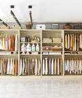 Built Different 12 Foot Modular Closet System With 8 Hanging Rods, Heavy Duty 4 Piece Wood Wardrobe Organizer With 2800 Lbs Capacity, White Oak Finish with clothing and storage baskets.