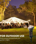 Heavy Duty Outdoor Power Stake Timer With Six Grounded Outlets And Six Foot Cord Weatherproof Mechanical Dial For Yard Lights And Garden Sprinklers 1875 Watt Capacity No Fuss Plug And Play in garden at night with lights.