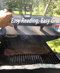 Grill with open lid showing meat cooking and two visible BBQ Grill Temperature Gauges. Text reads 'Easy Reading, Easy Grill.'