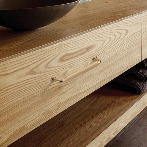 Super Sleek Brushed Brass Kitchen Cabinet Handles 10 Pack 5 Inch Metal Cupboard Pulls With Heavy Duty Screws on wooden drawer.
