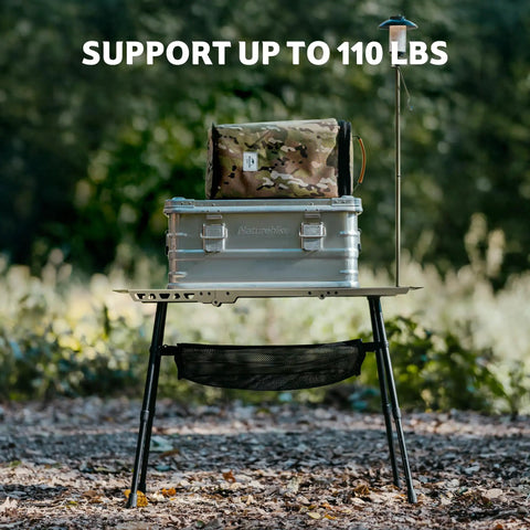 Grab And Go Tactical Camping Table With Adjustable Height From 14 To 23 Inches supporting cargo, in forest setting