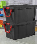 Two Pack 160 Quart Black Stackable Rolling Storage Bins with Heavy Duty Red Latches and Smooth Glide Wheels for Garage Organization.