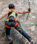 Climber using Half Inch By Hundred Feet Arborist Tree Climbing Rope Forty Eight Strand Polyester Static Bull Line on rock face.