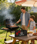 Father and son using 20 Piece Grilling Accessories Set For Outdoor Barbecue With Apron And Carry Bag; grill and tools visible
