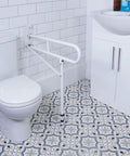 Heavy Duty Stainless Steel Toilet Safety Rails Featuring A Foolproof Flip Up Mechanism With Sturdy Leg Support For Secure Bathroom Access And Comfortable Shower Assistance mounted next to a white toilet.