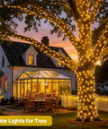 Illuminated tree and house with 2 Pack Solar String Lights Outdoor Waterproof 400 LED 151 Ft Total Warm White 8 Modes Solar Powered.