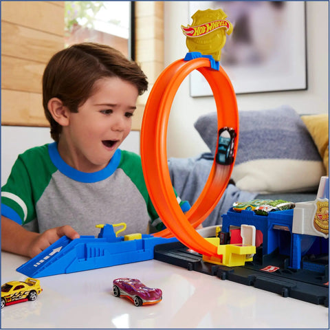 Child playing with Police Station Track Set With Adjustable Loop And Four Lane Race 1:64 Scale Die Cast Vehicle Included Multi Path Stunts