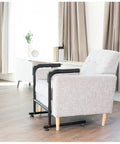 Heavy Duty Toilet Safety Rails With Padded Grip Handles Great For Seniors And Post Surgery Recovery To Help You Rise From Chair Or Couch Easily Bathroom Assist Bar Grab Support For Safe Mobility Transfers next to a grey chair.