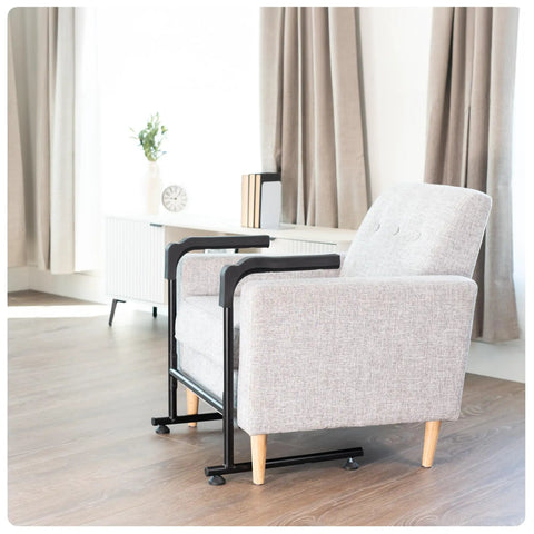 Heavy Duty Toilet Safety Rails With Padded Grip Handles Great For Seniors And Post Surgery Recovery To Help You Rise From Chair Or Couch Easily Bathroom Assist Bar Grab Support For Safe Mobility Transfers next to a grey chair.