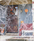 1000 Square Feet Spider Web Halloween Decor with 30 Fake Spiders White Cobweb Mesh on porch with pumpkins and flowers.