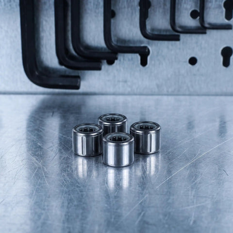 Four Piece One Way Clutch Bearing 8Mm ID 14Mm OD Silver Silent Ratcheting Flywheel Bearing for Weight Machines on metallic surface.