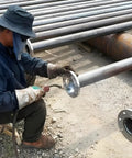 Worker welding 4 Inch Carbon Steel Slip On Flange With Neck Forged A105 Raised Face Class 150 ASME B16 5 2020 Pipe Fittings