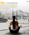 Woman practicing yoga indoors with view of neighborhood through Keep It Breezy With This Hands Free Magnetic Garage Door Screen 9x8 Ft.