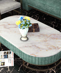 Oval table with gold marble top and flowers, showcasing 36 Inch By 197 Inch Gold Marble Countertop Contact Paper Waterproof Vinyl Marble Wallpaper Peel And Stick For Kitchen Counters Tables Desks Laminate Wrap Oil Proof Removable No Fading.