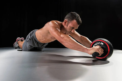 Killer Ab Rocker And Complete Core Toning Setup Featuring Rock Solid Ergonomic Handles Wide Non Slip Wheel With Heavy Duty Steel Coil For Serious Home Gym Strength Workouts And Ripped Physique during an ab workout.